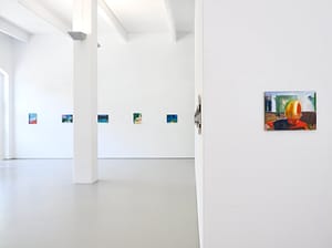 Contemporary art gallery installation in Galerie Onrust in 2022, showing vibrant paintings by Axel Linderholm on white walls. Featuring a colourful painting of a boy playing.