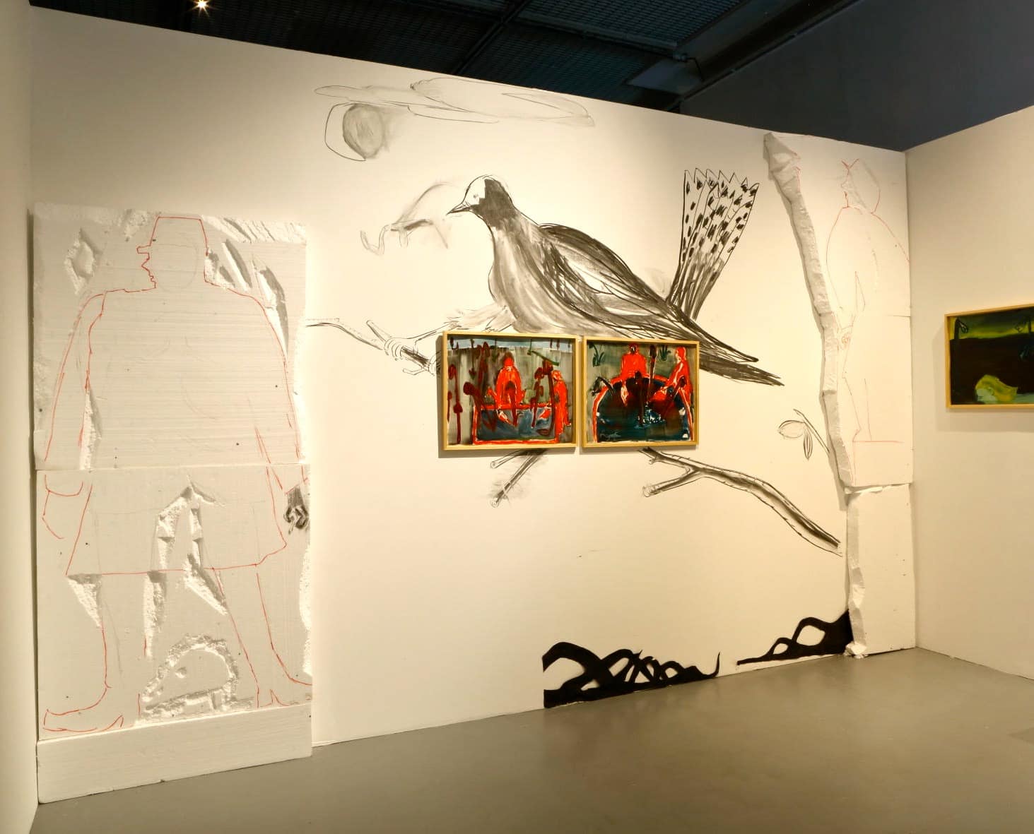 Art installation with dark atmospheric paintings, drawings of birds and a styrofoam sculpture of a man in the Centre for Contemporary Art Vilnius.